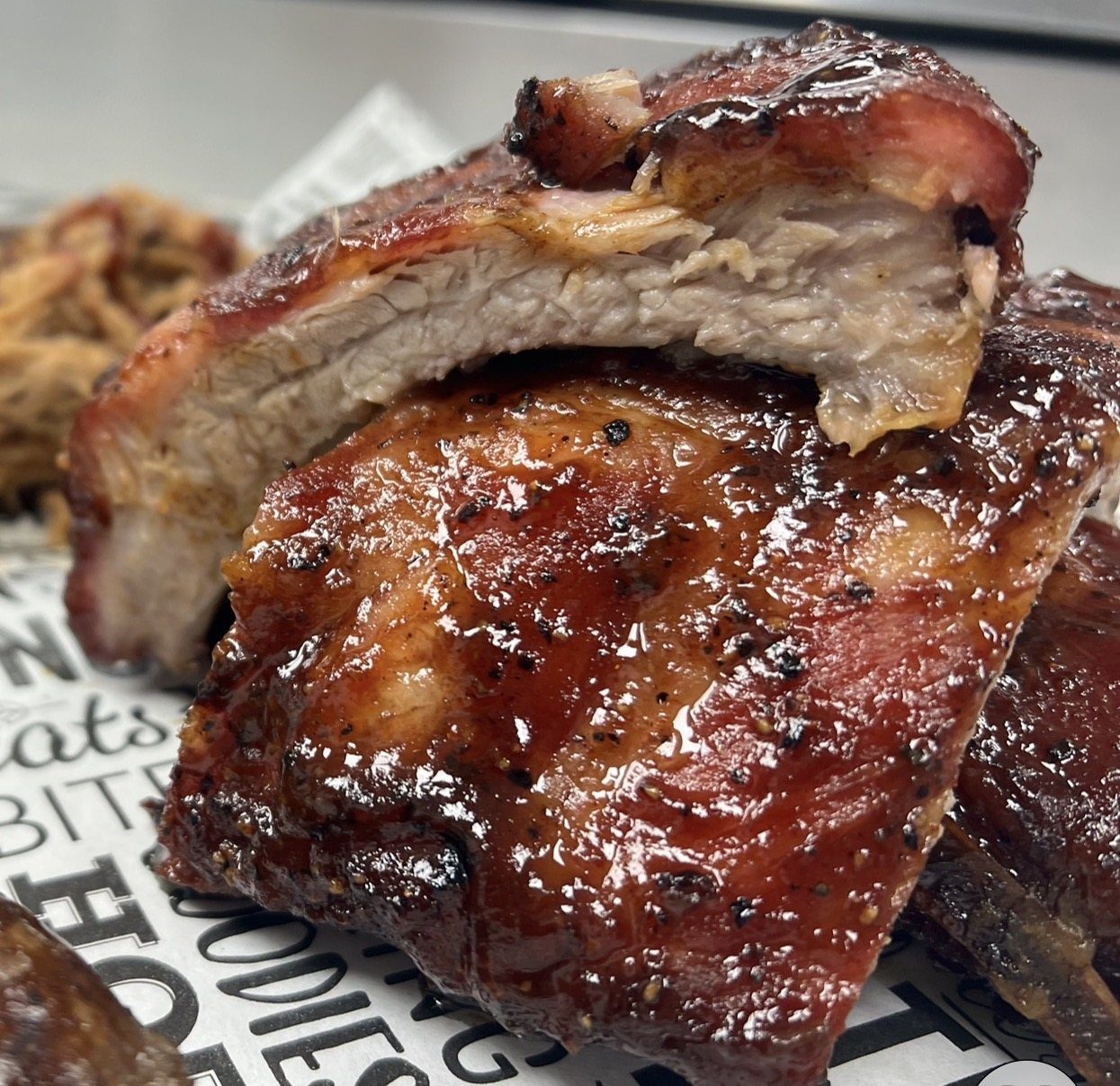 House-smoked ribs pulled apart to show the tender meat