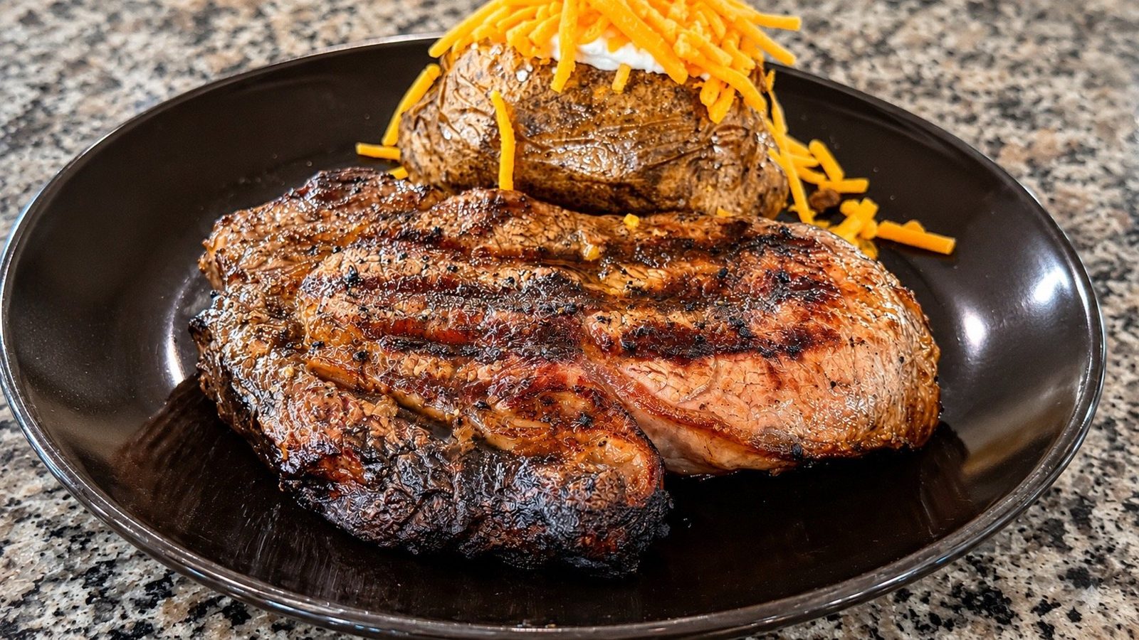 Hand-cut grilled steak with a loaded baked potato
